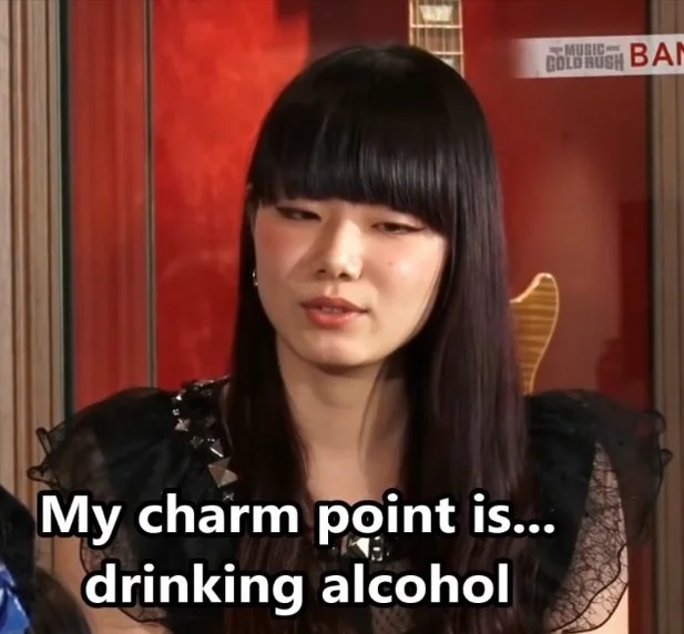 An asian woman.  "My charm point is... drinking alcohol."